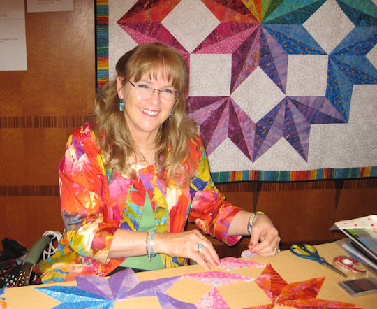 Jan with a Rainbow Split Broken Star quilt